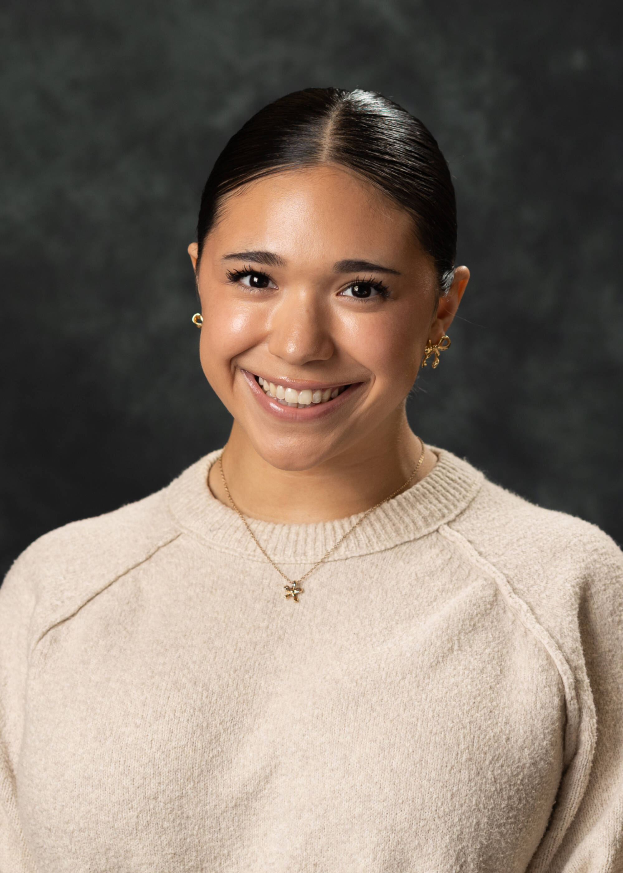 Elena Jimenez smiling in a cream-colored top